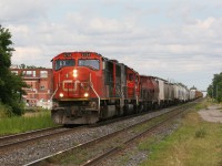 CN A435 is led by 4 locomotives westbound by the Woodstock VIA Station.  5734-5436-7245-231 make up this trains' lashup.