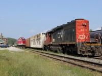 Algoma Central... CN 2575 + CN 2143 have a 24 car train 573 tucked away in track 3 (to depart a short while later as 571) ; CN 5379 is front coupled with 3 loaded log cars ; and the tri weekly passenger, train 632 makes its station stop.