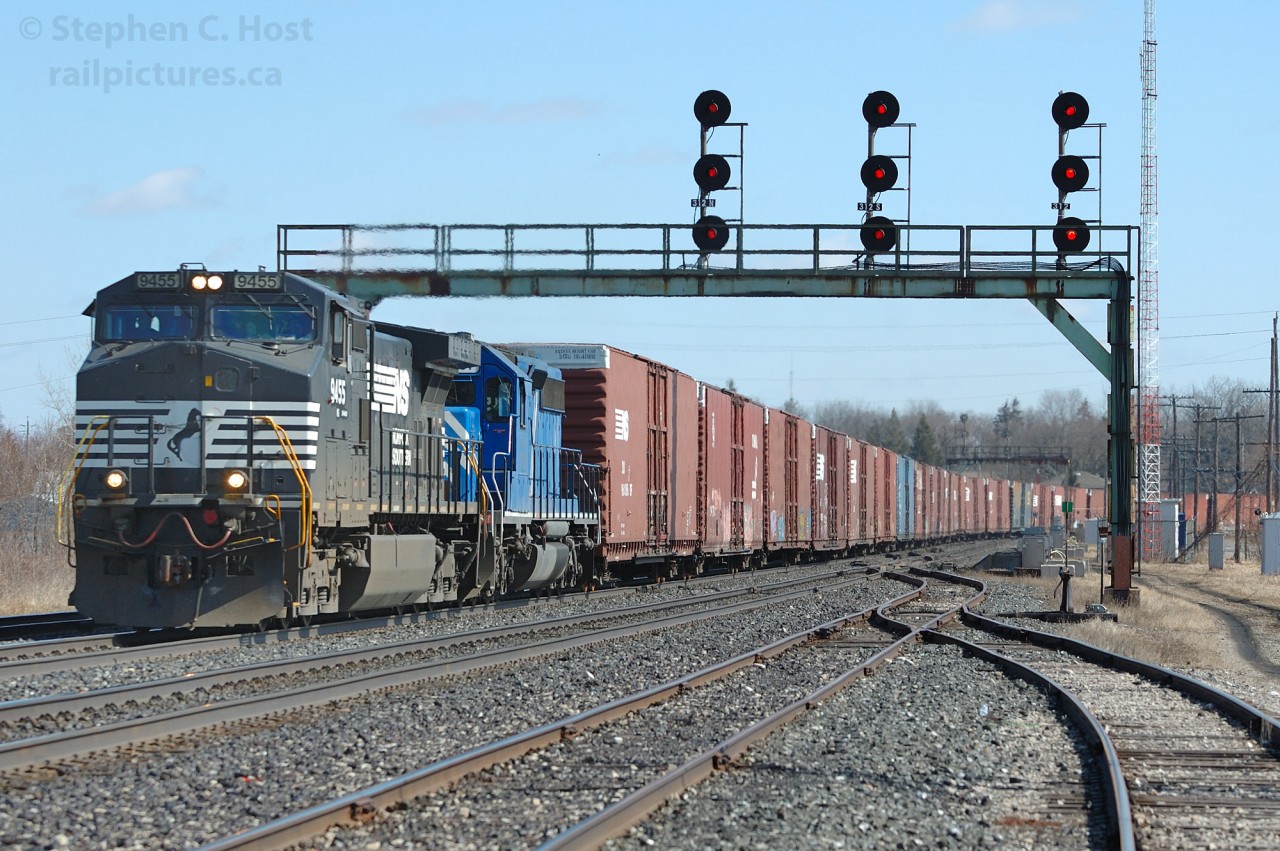 In 2006 I found myself in James Adney's former stomping grounds - a popular railfan spot is located on Railway St. where you get a clear shot and signals in both directions (as long as the SOR/CN interchange is not plugged full of cars blocking your view). 

In this scene, NS 327 is curving around onto the original Great Western Railway alignment at Paris, Ontario with a very long train of about 60 cars - auto parts for Talbotville and grain for St. Thomas and Eastern. 

The original alignment for the GWR curved slightly to the left and ran essentially straight through bypassing Brantford. Remnant yard tracks in Paris are all that remains of the original alignment still in service -  about a mile or two of abandoned track is also still in the ground with trees growing through it leading to the west bank of the Grand River. The rest of the northern alignment was abandoned in 1930 in favour of the GTR built Brantford bypass which was constructed about 1900.