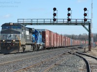 In 2006 I found myself in James Adney's former stomping grounds - a popular railfan spot is located on Railway St. where you get a clear shot and signals in both directions (as long as the SOR/CN interchange is not plugged full of cars blocking your view). <br><br>In this scene, NS 327 is curving around onto the original Great Western Railway alignment at Paris, Ontario with a very long train of about 60 cars - auto parts for Talbotville and grain for St. Thomas and Eastern. Talbotville was shut down the week prior and this was the first train after a week off, resulting in the extra traffic. 