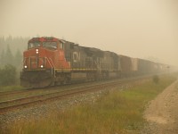 CN 347 leaving Edson on a perfectally clear and Sunny day.  Thats not fog you see in the pic.  Its forest fire smoke.  So bad it made my eyes burn. But had to get a shot. Thought it might be of interest