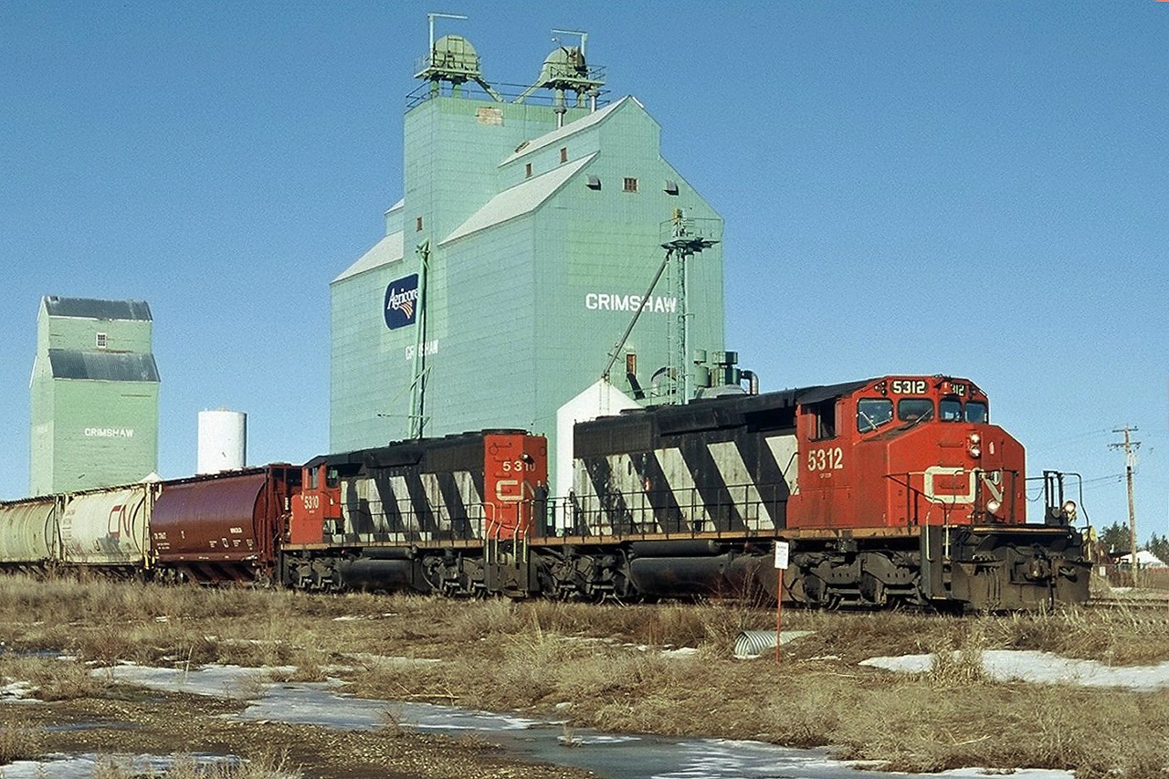 It's a long way north, the winters are long and summer short but the grain still grows.  SD40-2's CN 5312 and 5310 prepare to leave Grimshaw with a grain train on a sunny but cold march morning.