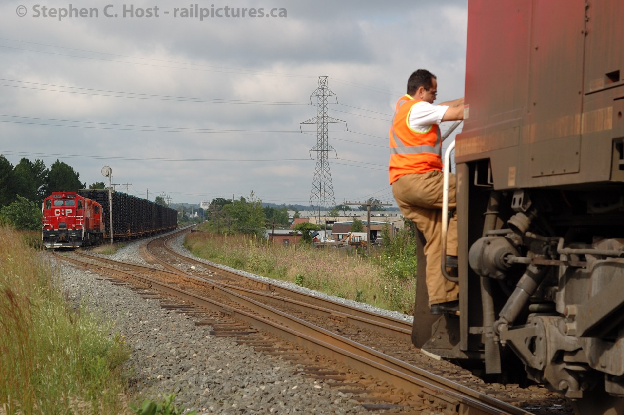 Killean siding is no more - as of 08/23/2013 this east switch, and the signal are removed, and the siding has been stub ended. Now it is called the "Killean Storage Track"
In this photo, the conductor of the westbound CP rack train, CP 9640 west (no other power) has manually thrown the switchto normal it and proceed westward. Train 142, the St. Thomas, Ontario to Oshawa, Ontario frame train is impatiently waiting to depart eastward. This was the last run of the scheduled Frame Train - the next day CP annulled the train opting instead to run the GM Oshawa traffic on Woodstock locals, being lifted by other trains en-route.