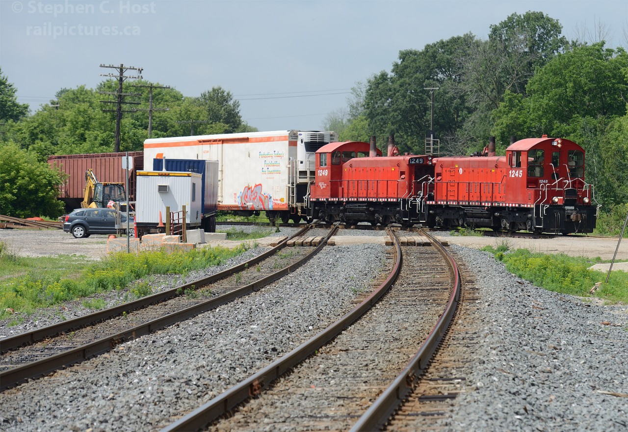The CN Dundas Subdivision's shiny rails reflect the red of the "pups" as the daily OSR eastbound job from Ingersoll glides over the raised diamond at Carew. Call me picky, but the fact the F unit was not on the train was actually to my delight - I much prefer a matched set of power and paint ;) Something tells me the Gypsy Queen agrees with me... :)