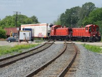 The CN Dundas Subdivision's shiny rails reflect the red of the "pups" as the daily OSR eastbound job from Ingersoll glides over the raised diamond at Carew. <br><br>Call me picky, but the fact the F unit was not on the train was actually to my delight - I much prefer a matched set of power and paint ;) Something tells me the Gypsy Queen agrees with me... :)