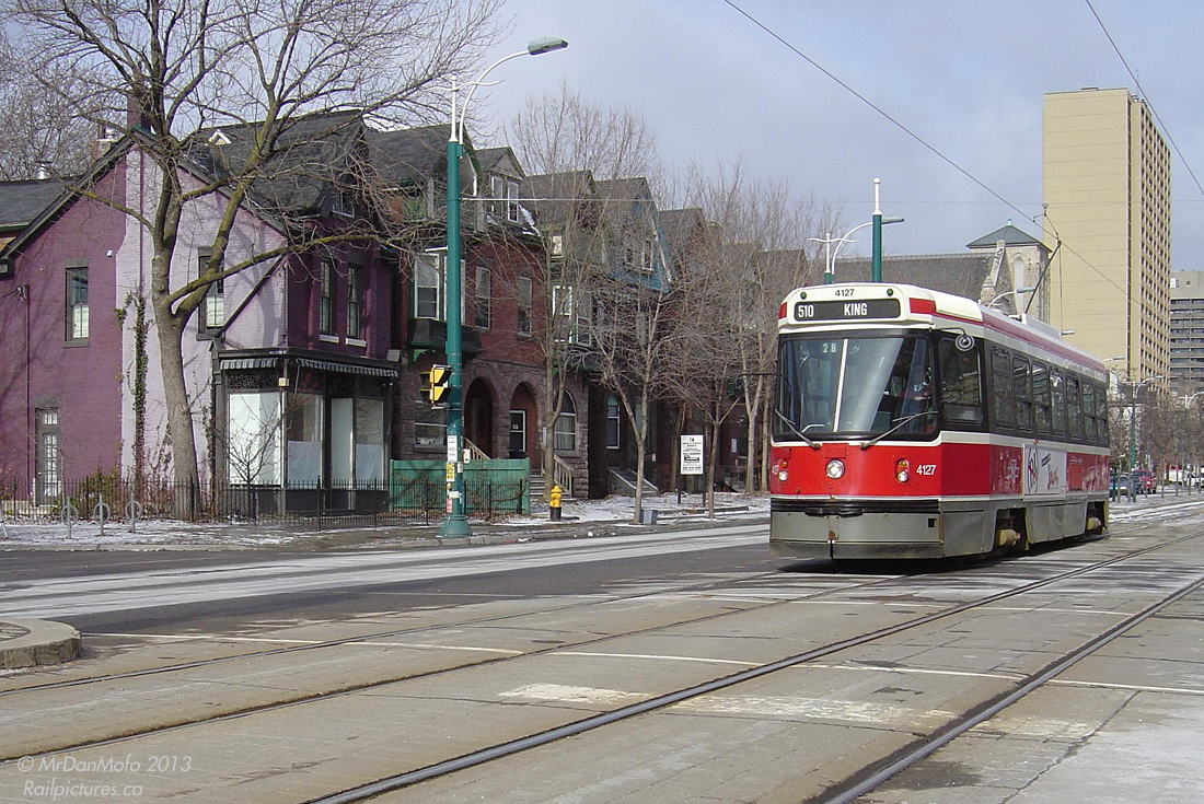 Rolling south on a 510 Spadina run (but short turning at King, hence the sign), TTC CLRV streetcar 4127 crosses the intersection of Spadina Avenue and Willcocks Street to pick up passengers waiting on the LRT platform to the south. The old row houses that line the west side of Spadina, likely dating from the mid-to-late 1800's, are a stark contrast to some of the more modern 1960's and newer apartments and offices to the north near Bloor, and much of the University of Toronto campus that lines the east side of Spadina.And for more Spadina action:Passing in the night: http://www.railpictures.ca/?attachment_id=8781Rounding 1 Spadina Crescent: http://www.railpictures.ca/?attachment_id=4867