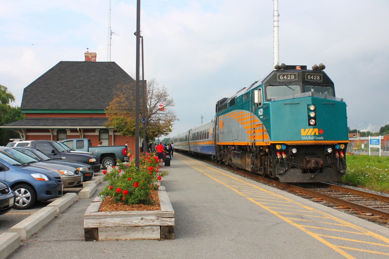VIA 72 lumbers into Chatham, stopping at the historic CN station. With the flowers bloomed in their boxes the bleak future of this station seems to be so far away. Soon it will be an unmanned station, no more days of walking up to the ticket counter, soon you'll just be swiping your plastic credit card. One more of the small remnants of rail travels romantic days will fade away. The grey cloud to the West almost foreshadowing the change.