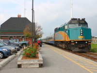 VIA 72 lumbers into Chatham, stopping at the historic CN station. With the flowers bloomed in their boxes the bleak future of this station seems to be so far away. Soon it will be an unmanned station, no more days of walking up to the ticket counter, soon you'll just be swiping your plastic credit card. One more of the small remnants of rail travels romantic days will fade away. The grey cloud to the West almost foreshadowing the change.