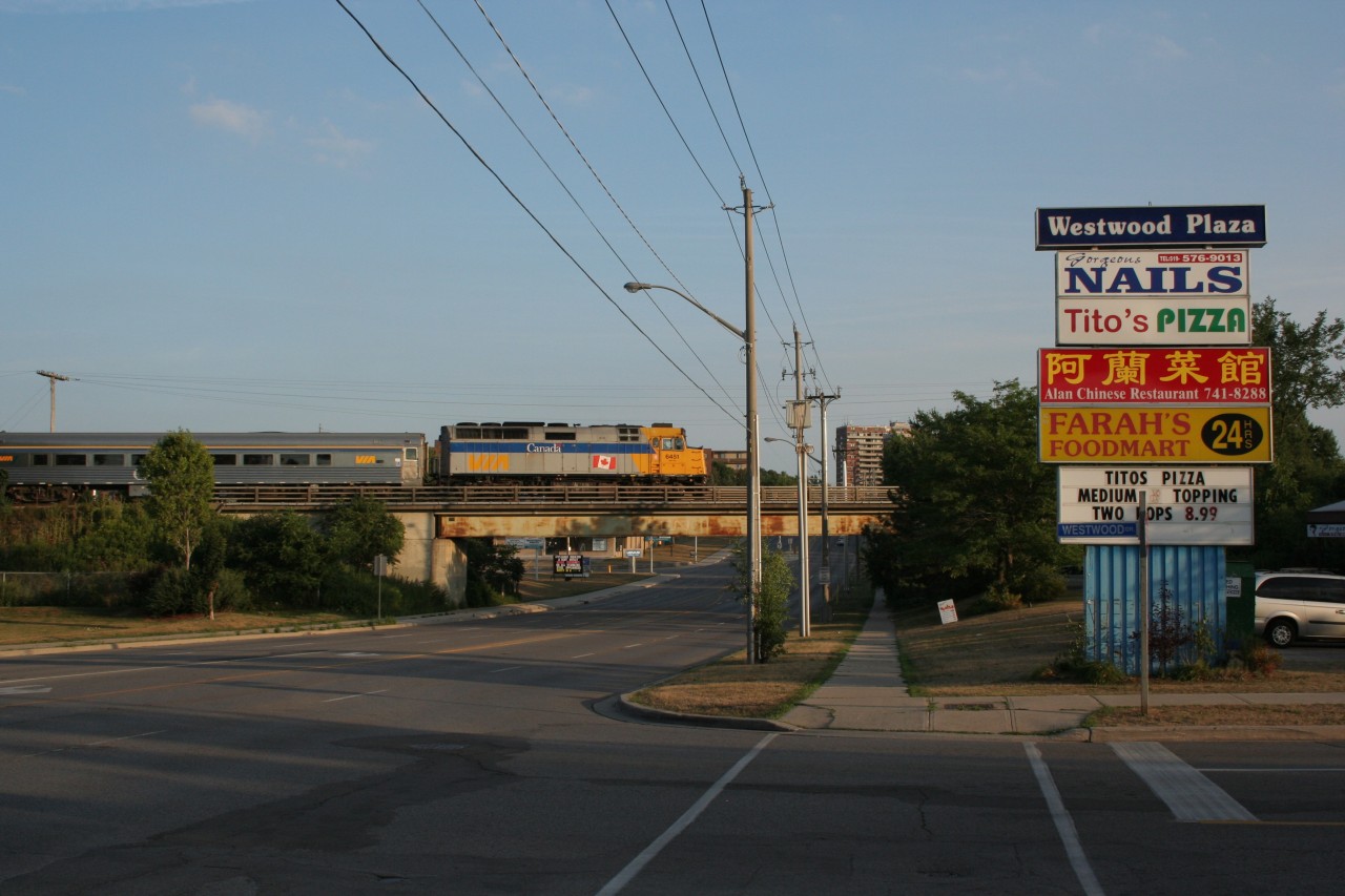 For a while I felt that this view needed to be captured with a train so I finally tried for a shot. This scene goes back two years in the summer of 2011. Here we see VIA F40PH number 6451 in its previous livery prior to the current one that drapes most or all VIA F40PHs now. Even the VIA didn't do justice to shatter the silence of this quiet scene of Westwood Drive and Westmount Road in the west end of Kitchener, in the subdivision of Victoria Hills. Note the old CN bridge with the CN noodle barely visible.