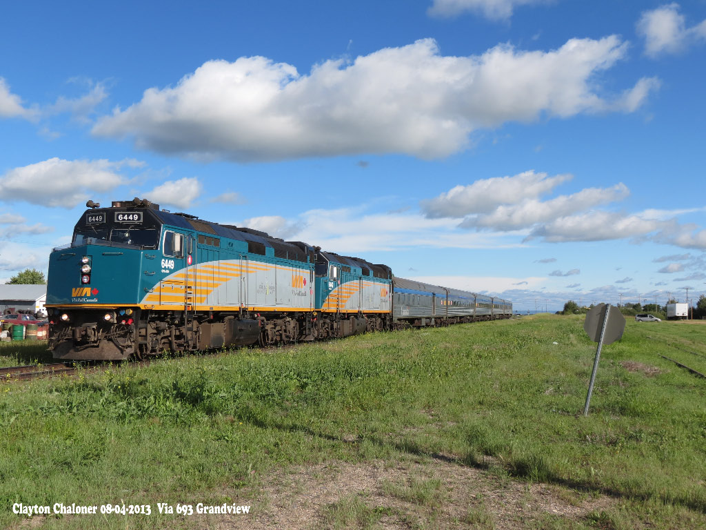 Via 693 is coming to a stop at Grandview on a sunny evening.