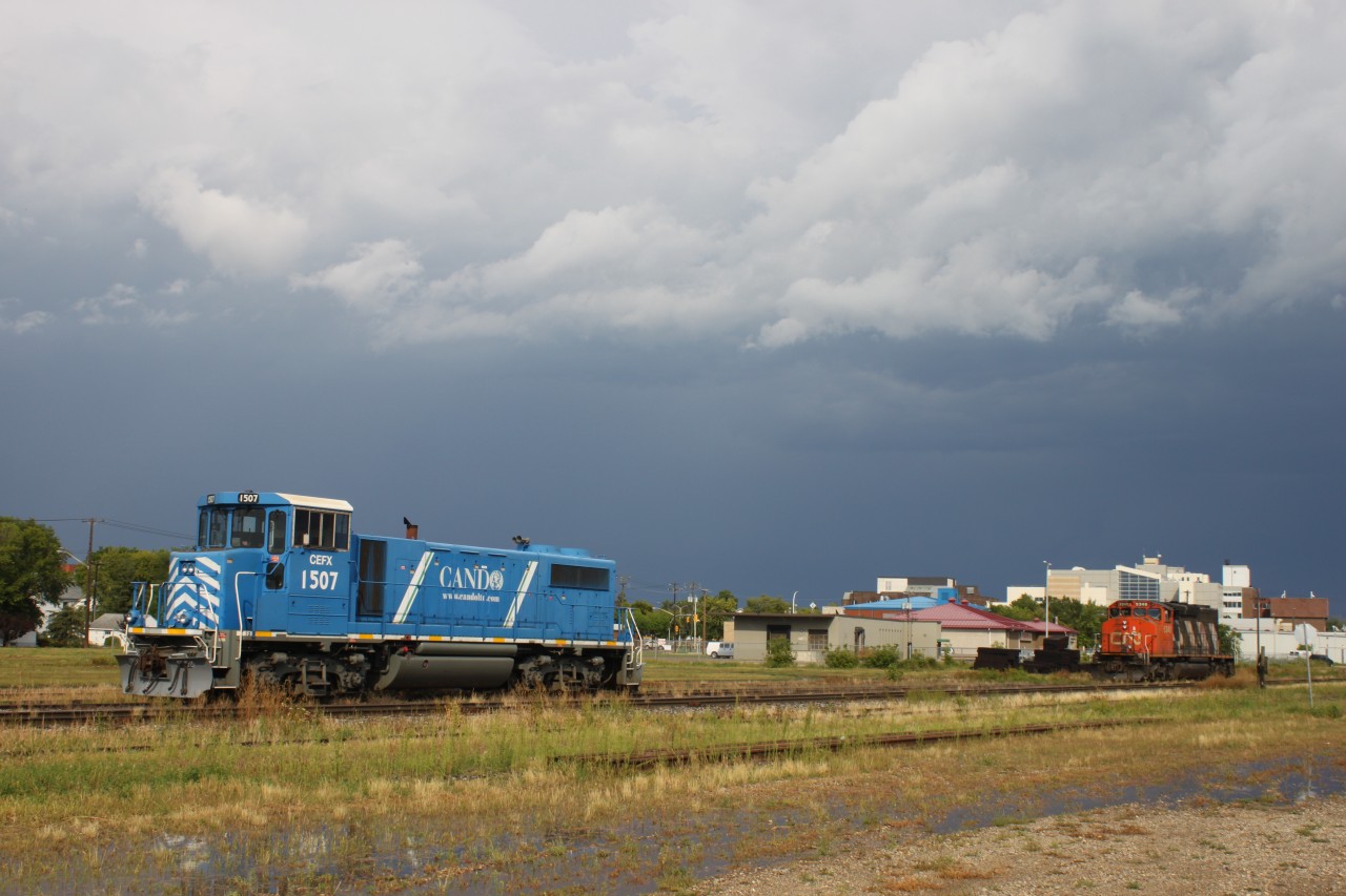 CEFX 1507 sits next to CN 5448 in the CN Brandon Yard after an intense rain storm.