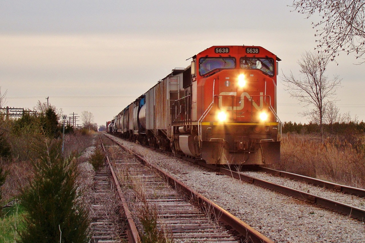 CN 5638 is in charge of today's daily Windsor to London freight, on his way back home west to Windsor. The train has just turned off of the former CSX Sarnia sub (in CN control from Chatham to Blenheim) and onto the now gone CASO sub. Within three weeks these rails would be abandoned.