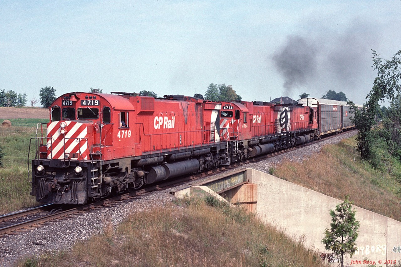 A trio of MLW M-636s with #4719 in charge, leads a westbound autorack train over the CN York sub at Beare (west of CP's Cherrywood siding) in September 1989.
