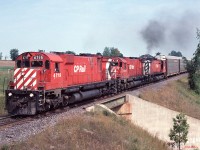 A trio of MLW M-636s with #4719 in charge, leads a westbound autorack train over the CN York sub at Beare (west of CP's Cherrywood siding) in September 1989.