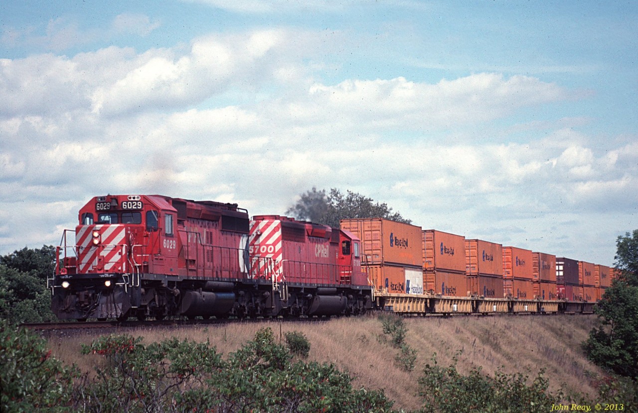 A pair of CP SD40-2s lead a double-stack train westbound at Woolacott Lane (west of Port Hope siding) in September 1993.