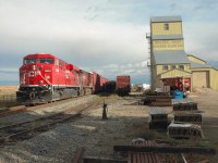[Editors note: this photo has been corrected] 8849 is southbound through Balzac Alberta.  Sadly the Balzac Seed Cleaning elevator is now gone and replaced with a fenced off lumber yard.  