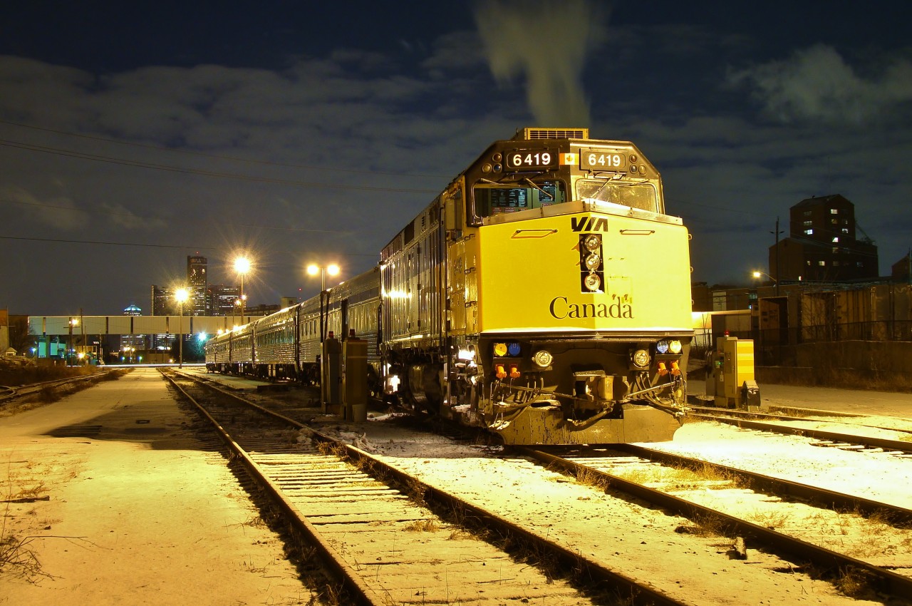Non rebuilt VIA F40PH-2 6419 sits quietly under the night sky waiting for a morning trip to Toronto. The smoke above the unit is coming from the Hiram Walker Distillery along Windsor's waterfront.