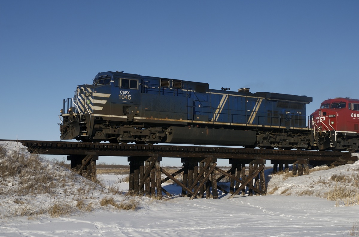 CP tran 457 (Sutherland SK to Calgary AB) is headed up by CEFX 1045 and CP 8887 on January 20th 2009 as it passes over an ancient bridge near Kinley SK. I drove past this spot again on Sept 13, 2013 only to see that the bridge has been replaced by back fill and steel culverts.