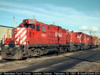 A pair of GP9's have an RS23 sandwiched as the Aberdeen Turn power rests at the house in the Quebec Street yard in London, Ontario back in 1991.