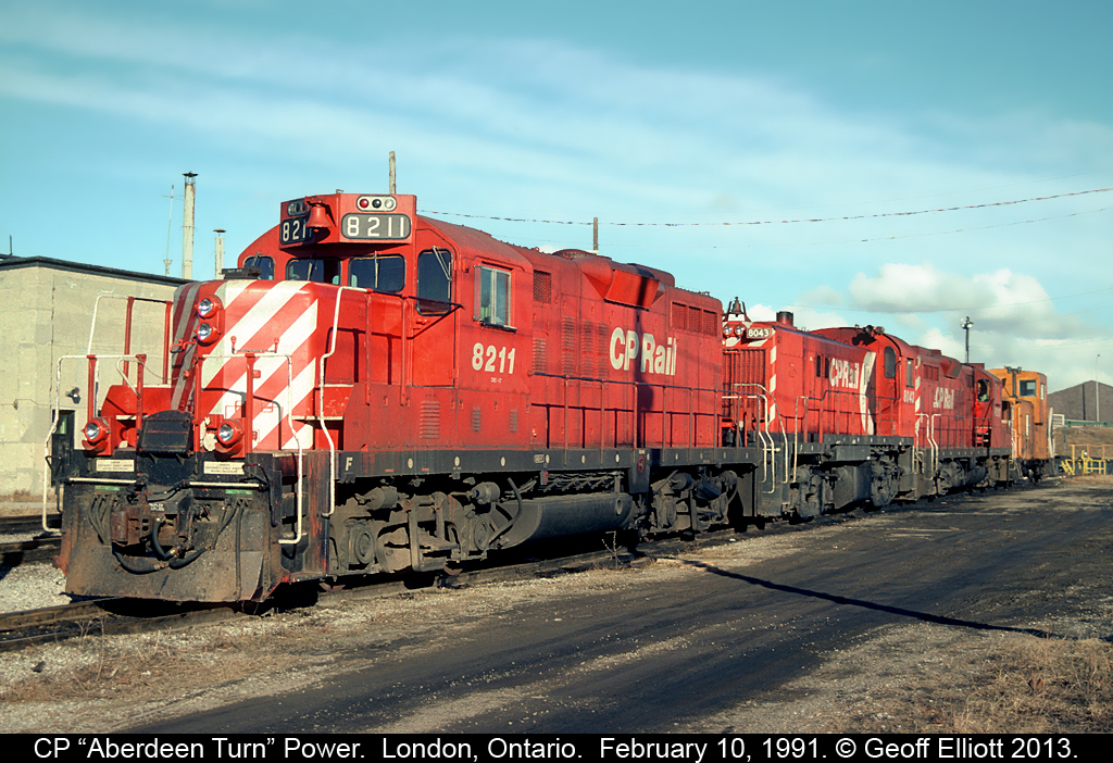 A pair of GP9's have an RS23 sandwiched as the Aberdeen Turn power rests at the house in the Quebec Street yard in London, Ontario back in 1991.
