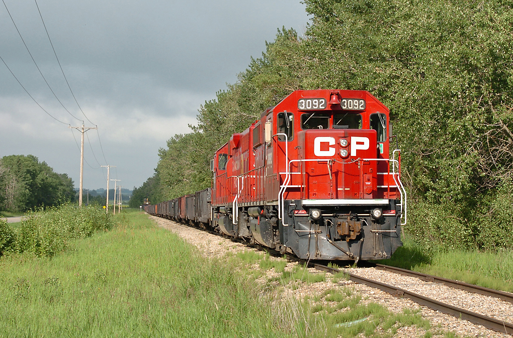 A rare move, CP Work Hoadley with 3092 and 3020 is shown here idling at Aspen Beach. The day after this photo was taken, the train would move farther to around Forshee. The Hoadley Sub had been very inactive for around two years prior, due to poor track conditions and (rumored) contract issues with their only producer on the line, the gas plant at Homeglen/Rimbey. It was quite active in 2012, but traffic seems to have greatly declined again in 2013.