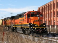 <b>FPON BABY!</b>
<br><br>
Until CN got better with turning power back at the border and stricter requirements for lead locomotives to be equipped with CN crew amenities, lots of goodies made their way into Canada on CN freights, some often leading. This became known as FPON, or "Foreign Power in ONtaro", and there was always the potential for something new or neat trackside. Burlington Northern Santa Fe and Union Pacific were by far the most popular two, although other roads' power showed up as well. February 2007 finds this photographer trackside to catch a pair of matching BNSF pumpkins as sole power on CN freight 390 through Brampton. The lead unit, GP50 3124, had been repainted with the new "Powerbar" lettering a little over a year ago, but still shone in the afternoon winter's sun.
<br><br>
Also, VIA 6429 (the Barf-green Telus unit) was doing the honours on #85 that afternoon, departing the station at the same location just 10 minutes earlier: <a href=http://www.railpictures.ca/?attachment_id=6825><b>http://www.railpictures.ca/?attachment_id=6825</b></a>.