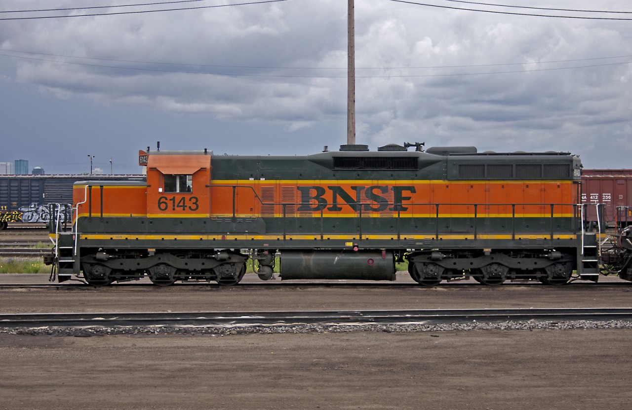 Someone pulled a fast one! BNSF SD9 6143 pays back horespower hours to CN in 2005.