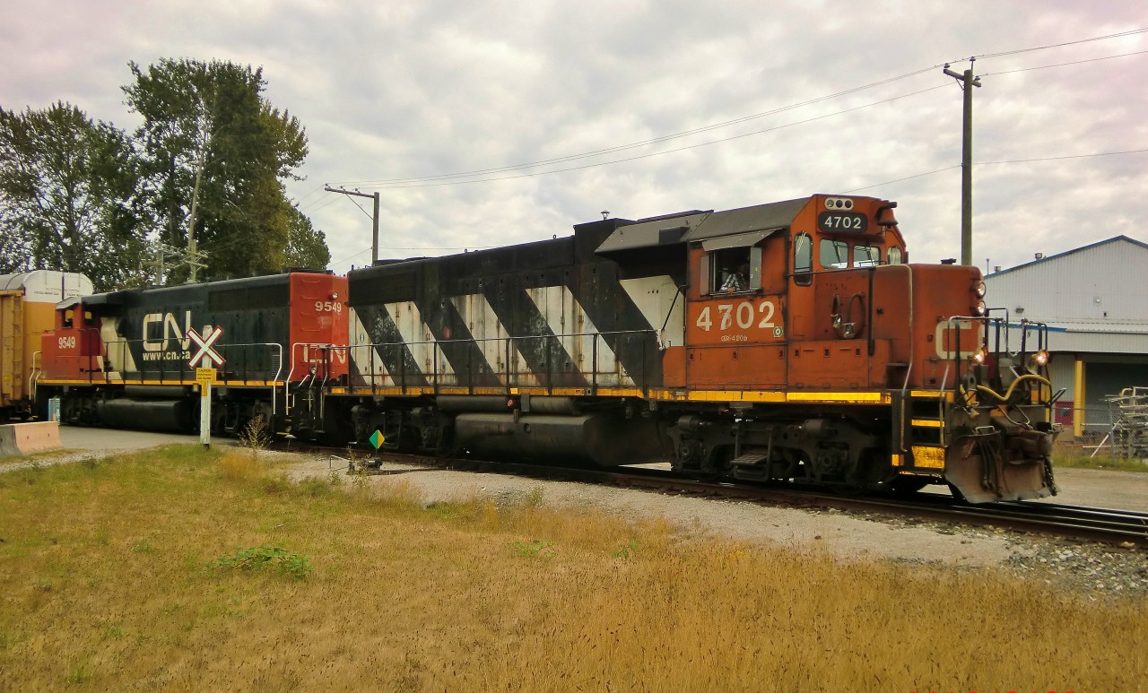 Two CN geeps back up a train of auto racks into fraser fiver terminals.
