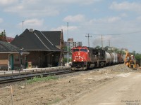 Another from the FPON files (awww yeeeeah):
<br><br>
With the construction of the south platform as part of expanding GO Georgetown (later Kitchener) line service, all the years of debris, foliage, trees and junque on the south side of Brampton Station had to be cleared out, resulting in a nice wide-open shot (that ironically later vanished when the new platforms and shelters were put in). On a sunny Sunday afternoon, CN #399 rolls past the 101-year old station (built new by the Grand Trunk in 1907) and parked construction equipment, along the closed Railroad Street. Power today is CN SD75I 5773 leading NS "Catfish" C40-8W 9570 rear-to-rear, reppin' the FPON content for today.