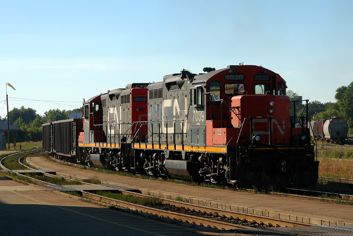 A pair of 1950's built GMD GP9RM's shoving hard on the tail end of CN 435, who has CN 8002 - BCOL 4618 - CN 7029 on the head end