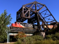 Q101's mid train DPU exits the west end of CN's crossing of the Red River.