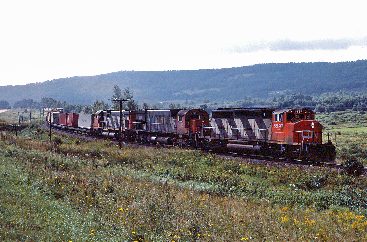 CN 5297, CN 2325 and CN 2035 lead a westbound extra into Saint Basile, New Brunswick, the crew is about five miles away from a crew change at Edmunston.