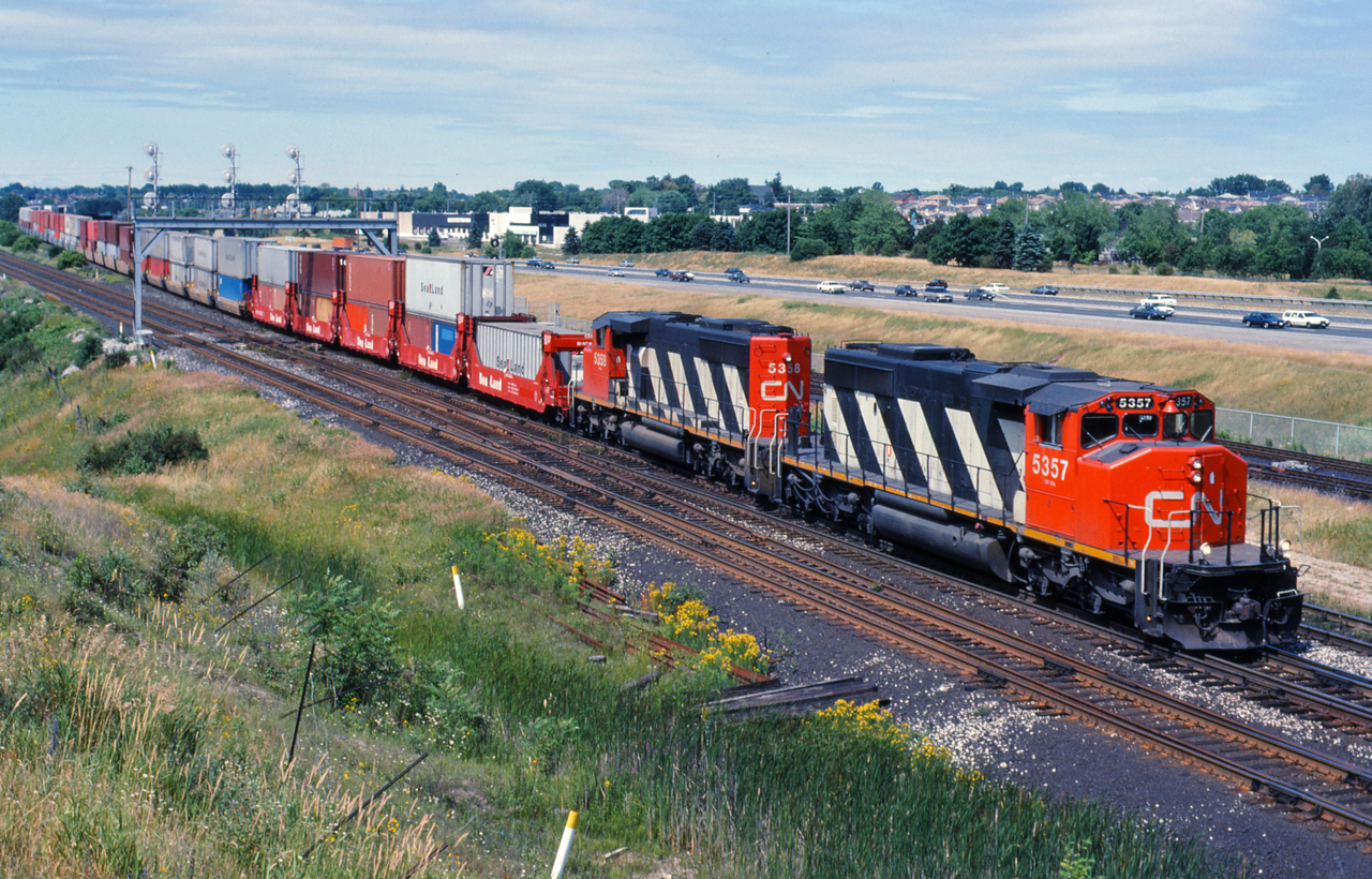 CN 5357 and 5358 lead an eastbound intermodal train off the York Sub at Pickering
