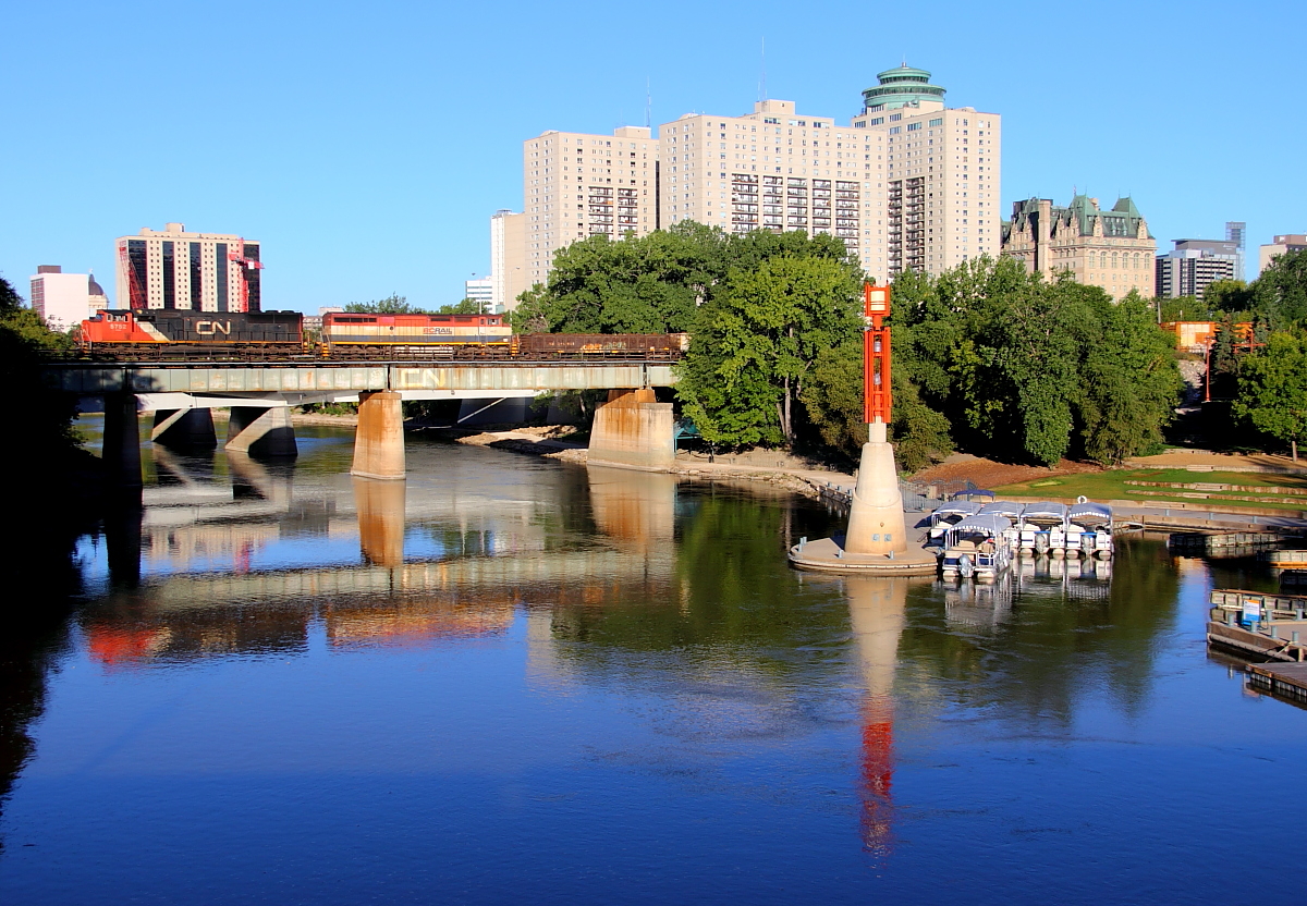 A CN manifest crosses the Assiniboine River just west of Winnipeg's Union Station.