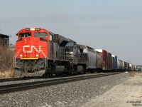 <b>"Quickie"</b>
<br><br>
On the way home from some errand at Shoppers' World otherwise too mundane to be memorable, a probable squawk out of the VX150 telling us CN 399 was approaching necessitated a pit stop behind our favourite deserted big box plaza photo spot off Kennedy Road. At the time the 3rd track of CN's Halton Sub had not been laid, and the area of "old Peel" was nice and wide open for decent train shots (even if the light was straight down the track at this time of day). It almost made the horrible stench from the nearby asphalt shingle plant tolerable.
<br><br>
But anyway: Our short 399, the tail end of which can be seen in the distance under the Highway 410 overpass, is dodging the evening GO trains while making a break for freedom at CN Silver (Georgetown) and beyond. Nearly new at the time CN SD70M-2 8020 is on point, with NS "Catfish" C40-9W 9555 reppin' the FPON content that made "quickies" like this more "I wonder what interesting foreign thing will turn up" rather than today's "I wonder what boring CN thing will be on it", to paraphrase a friend.