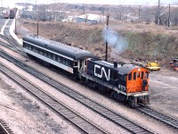 CN 8173 moves a business car through the yard at Hamilton.