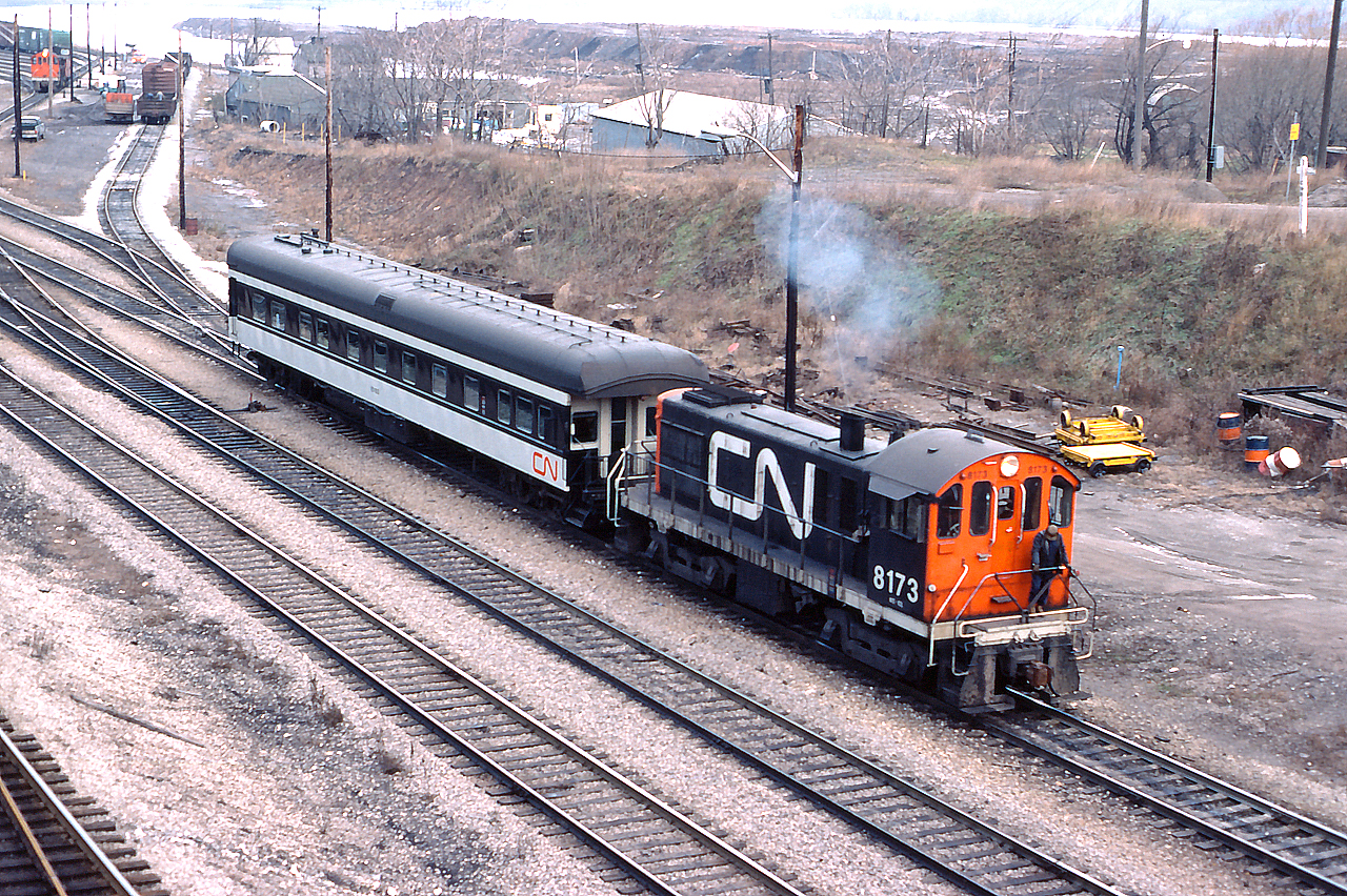 CN 8173 moves a business car through the yard at Hamilton.
