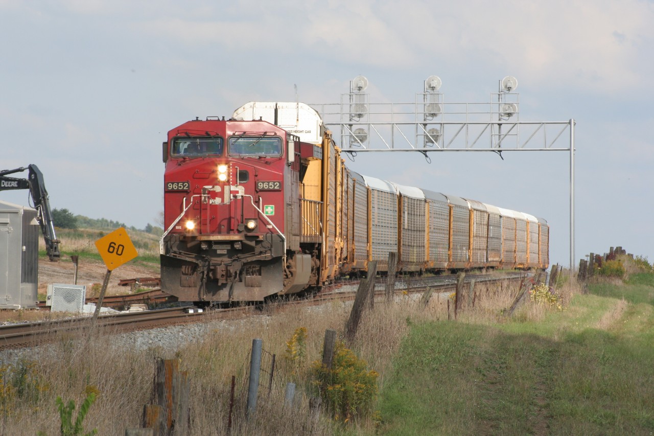 A lone CP GE begins to pull a string of auto racks out of the west end of CTC Wolverton on a late September afternoon.