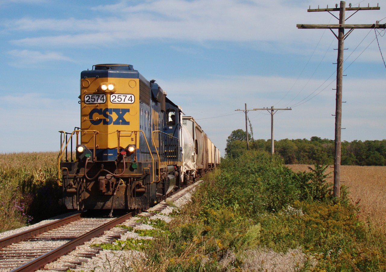 The final run. On a gorgeous early fall day, CSX local D924 heads west out of Dresden after running around it's train so he can switch Tupperville and proceed back north to Sarnia. This will be the last train over these rails, and service to Wallaceburg is said to cease before October 2 2013. Ownership of the line will be changing hands from CSX to the Municipality of Chatham-Kent on October 3, and if a shortline operator isn't found before that time, these rails face a very uncertain future. A deal with CANDO fell through during the summer, although there are a couple of other contenders interested in operating the line, but if C-K cannot close on a deal before the deadline, CP (who has an agreement with C-K to hold possession of the rails) has threatened to scrap the rail.