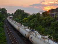 A loaded TankTrain bound for Maitland, Ontario, heads west at sunset. Head end power (out of sight) is CN 2172 & CN 9531.