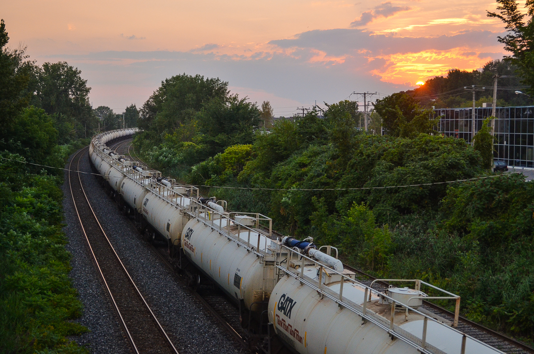 A loaded TankTrain bound for Maitland, Ontario, heads west at sunset. Head end power (out of sight) is CN 2172 & CN 9531.