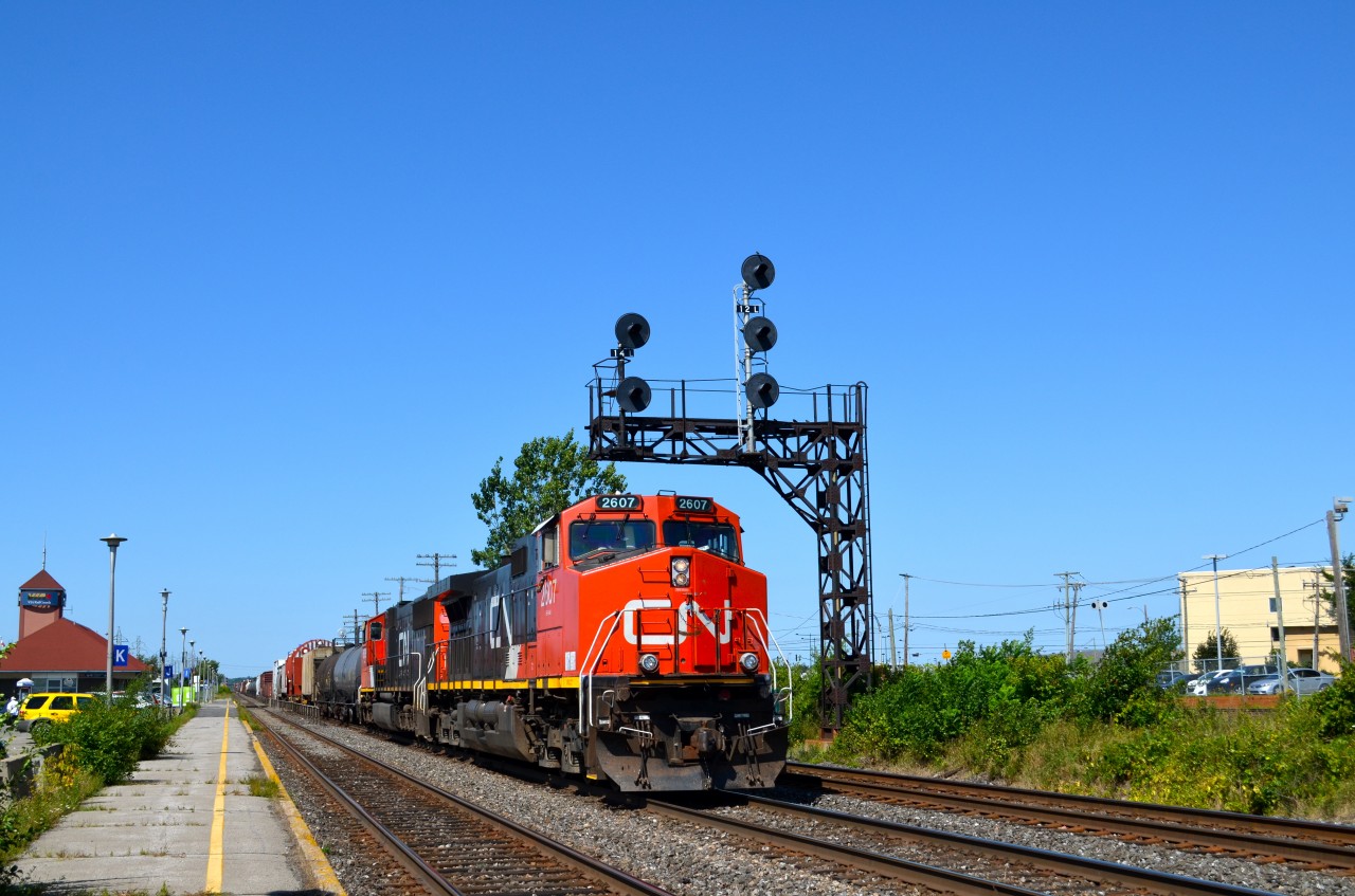 CN 2607 & CN 5629 head east past VIA's Dorval station with CN 368 in tow.