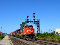 CN 2607 & CN 5629 head east past VIA's Dorval station with CN 368 in tow. 