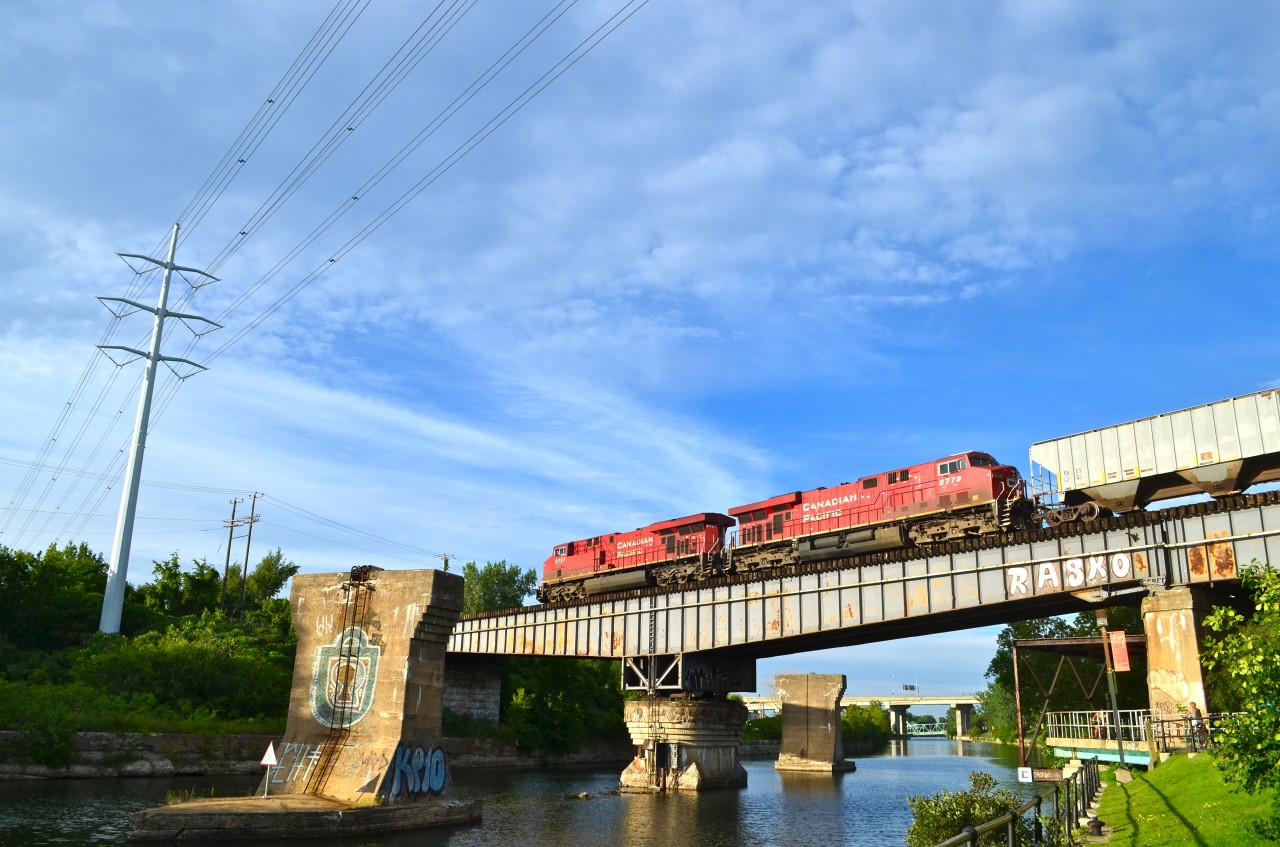 This CP train is crossing the Rockfield Bridge over the Lachine Canal. It is led by CP 8727 & CP 8779 and is composed of mostly empty tank cars.