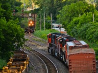 CN 5650, CN 5699, CN 9566 & CN 7246 at the head end of an eastbound cool their heels as CN 8963 (leading CN 309) is visible in the distance, heading west. On the far left are stored well cars and on the far right track, a VIA eastbound train will soon pass. For more train photos, check out http://www.flickr.com/photos/mtlwestrailfan/.