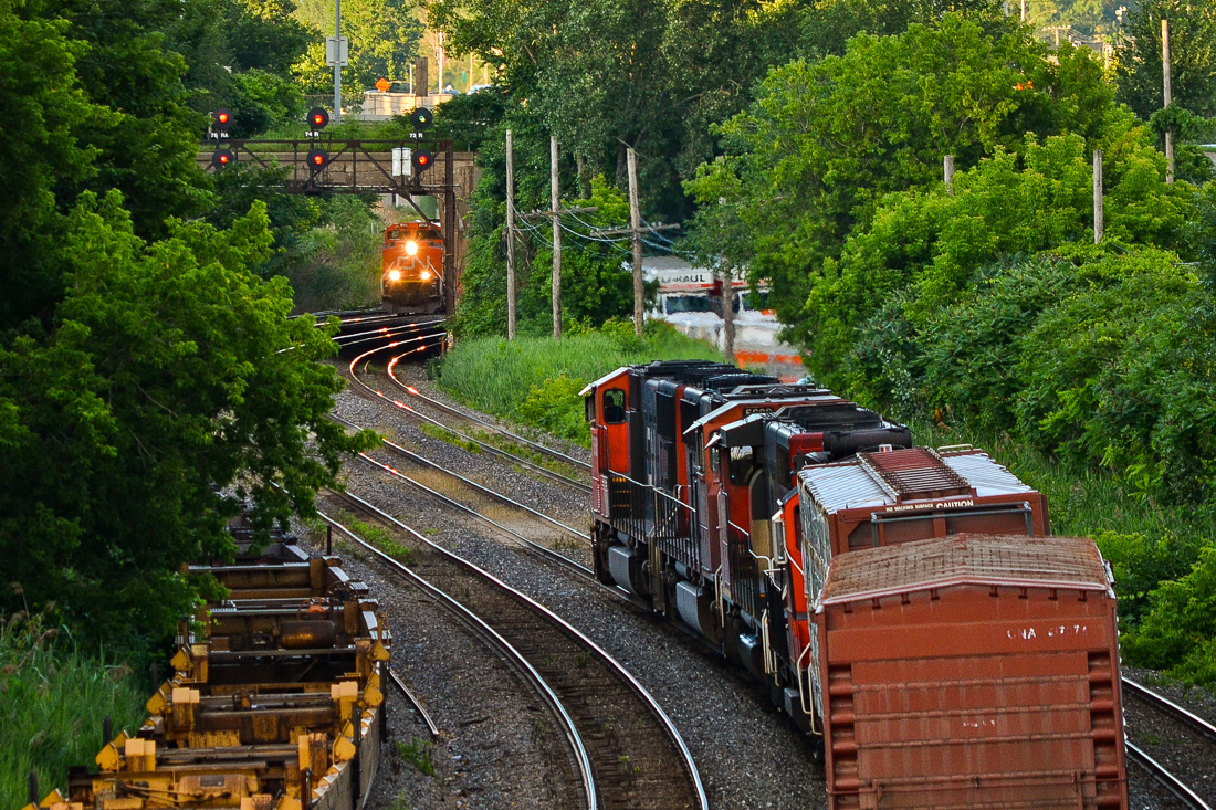CN 5650, CN 5699, CN 9566 & CN 7246 at the head end of an eastbound cool their heels as CN 8963 (leading CN 309) is visible in the distance, heading west. On the far left are stored well cars and on the far right track, a VIA eastbound train will soon pass. For more train photos, check out http://www.flickr.com/photos/mtlwestrailfan/.
