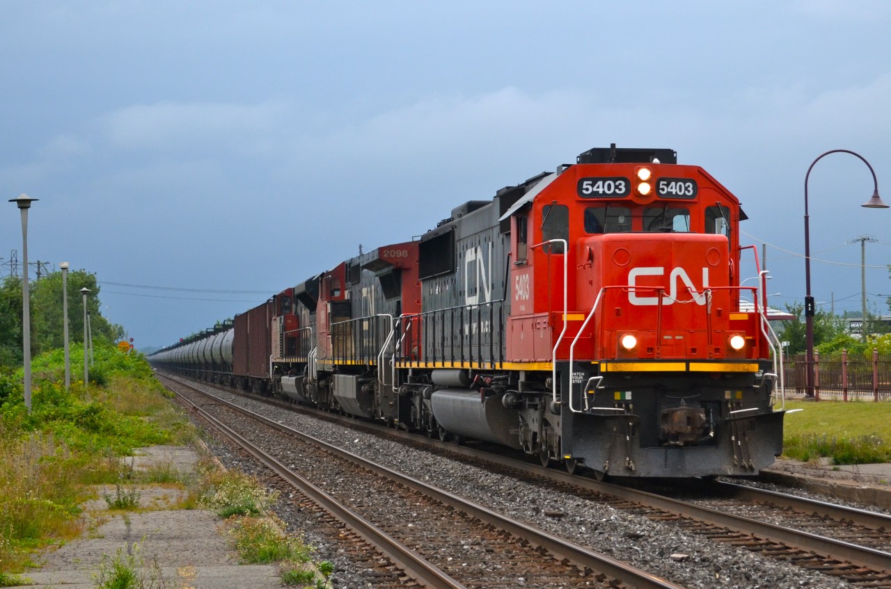 CN U700 with 96 loaded crude oil cars and two buffers cars heads east through Dorval with CN 5403, CN 2098 & CN 8919 at the head end. There was no DPU. This train originated on BNSF in North Dakota and is headed to St-John, New-Brunswick. CN 5403 was originally Oakway 9028 and CN 2098 was originally ATSF 865.