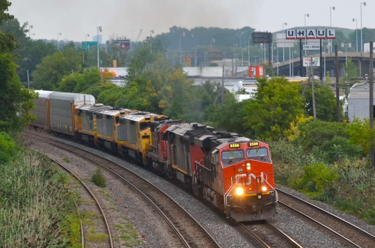 Passing westbound through Montreal West is CN 401 with 3-ex Quebec, North Shore & Labrador Dash8-40CM's in tow, on their way to new owners (The Andersons Rail Group). They were acquired new from GE in 1994, the only three they owned of that type. With a lot new power joining the QNS&L fleet recently, they became expendable. The consist was CN 2330, CN 2440, CN 4730, AEX 100017, AEX 100019 & AEX 100018.