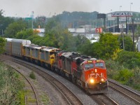 [Editors note: Rare power trailing unit in less than ideal conditions] Passing westbound through Montreal West is CN 401 with 3-ex Quebec, North Shore & Labrador Dash8-40CM's in tow, on their way to new owners (The Andersons Rail Group). They were acquired new from GE in 1994, the only three they owned of that type. With a lot new power joining the QNS&L fleet recently, they became expendable. The consist was CN 2330, CN 2440, CN 4730, AEX 100017, AEX 100019 & AEX 100018. 