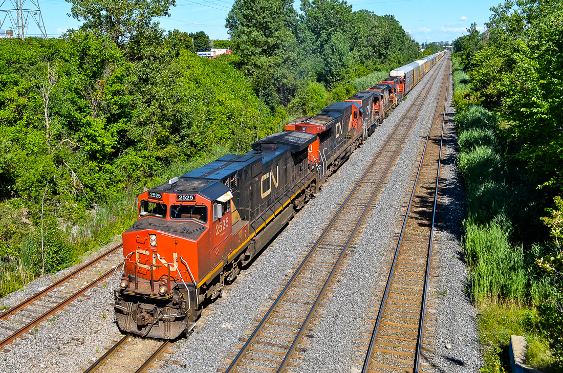CN 401 has a nice five unit lashup consisting of CN 2525, CN 2116, CN 9418, CN 4723 & CN 9566. It is just a few minutes away from tying up at nearby Taschereau Yard as it heads west under the Norman Street overpass. For more train photos, check out http://www.flickr.com/photos/mtlwestrailfan/